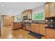Kitchen features wooden cabinets, stainless steel appliances, black countertop, hardwood floors, and natural light at 1728 N Holly Ne Ln, Atlanta, GA 30329