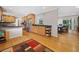 Open kitchen featuring stainless steel appliances, wooden cabinetry, and hardwood floors leading to a dining area at 1728 N Holly Ne Ln, Atlanta, GA 30329