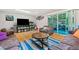 Open living room features hardwood floors, skylight, and sliding glass doors to a patio at 1728 N Holly Ne Ln, Atlanta, GA 30329