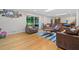 Bright living room with hardwood floors, couches, and sliding door to back porch at 1728 N Holly Ne Ln, Atlanta, GA 30329