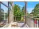 Charming balcony with wooden floors, a small table and a neighborhood view through black metal railings at 22 Moda Ln, Atlanta, GA 30316