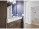 Bathroom with modern vanity, granite counters, modern fixtures, large mirror and wood floors at 22 Moda Ln, Atlanta, GA 30316