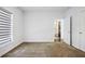 Empty bedroom with carpet, a bright window with blinds, white walls and trim and entry into the bathroom at 22 Moda Ln, Atlanta, GA 30316