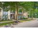 Modern condo building with landscaped green space and beautiful trees at 22 Moda Ln, Atlanta, GA 30316