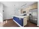 Bright, open kitchen with stainless steel appliances and a large center island with a blue accent at 22 Moda Ln, Atlanta, GA 30316