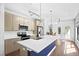 Modern kitchen with stainless steel appliances, large island, pendant lighting, and ample cabinet space at 22 Moda Ln, Atlanta, GA 30316