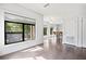 Well-lit living room that flows into kitchen with hardwood floors and multiple windows at 22 Moda Ln, Atlanta, GA 30316