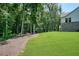Large backyard with a seating area and firepit backing onto mature trees at 2861 Digna Ct, Acworth, GA 30101