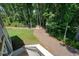 Well-maintained backyard with lush green lawn and a fire pit area surrounded by mature trees at 2861 Digna Ct, Acworth, GA 30101