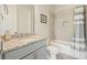 Tiled bathroom with granite countertop vanity, framed mirror, and shower-tub combination with modern fixtures at 2861 Digna Ct, Acworth, GA 30101