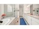 Bathroom with a soaking tub, walk in shower, double vanity, and a blue geometric rug at 2861 Digna Ct, Acworth, GA 30101