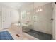 Bathroom showing a soaking tub, walk in shower, neutral walls and floors, and a blue rug at 2861 Digna Ct, Acworth, GA 30101
