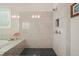 Bathroom with a frameless glass shower with tiled walls and floors, plus tub view from the walk in shower at 2861 Digna Ct, Acworth, GA 30101