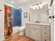The stylish bathroom has blue tile, a shower/tub combo, and a vanity with a marble countertop at 2861 Digna Ct, Acworth, GA 30101