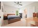 Comfortable bedroom featuring neutral walls, ceiling fan, and carpet flooring with a view to the ensuite at 2861 Digna Ct, Acworth, GA 30101
