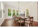 Elegant dining space with hardwood floors and windows bringing natural light and scenic backyard views at 2861 Digna Ct, Acworth, GA 30101