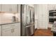 Stainless steel refrigerator and granite countertops in kitchen with white cabinetry at 2861 Digna Ct, Acworth, GA 30101