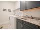 Functional laundry room with washer, dryer, granite counters, and dark cabinets for ample storage at 2861 Digna Ct, Acworth, GA 30101
