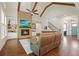 Living room with brick fireplace, wood beams, and open staircase at 2861 Digna Ct, Acworth, GA 30101