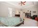 Bright primary bedroom with tray ceilings, a ceiling fan, and an ensuite bathroom with a double sink at 2861 Digna Ct, Acworth, GA 30101