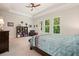 Large primary bedroom featuring a ceiling fan, tray ceilings, and multiple windows overlooking a treed lot at 2861 Digna Ct, Acworth, GA 30101