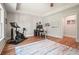 A home office is well-lit with desk space, an exercise bike, and tray ceiling detail at 2861 Digna Ct, Acworth, GA 30101