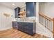 The wet bar features custom blue cabinets, tile backsplash, and a beverage fridge, ideal for entertaining guests at 2861 Digna Ct, Acworth, GA 30101