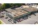 Overhead view of a commercial building with parking and storefronts, Oak Grove Market and Cleaners at 1377 Oak Grove Dr, Decatur, GA 30033