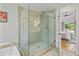 Modern glass shower featuring dual shower heads, tile surround, and natural light at 1377 Oak Grove Dr, Decatur, GA 30033