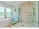 Modern bathroom featuring a freestanding tub, glass shower, and natural light at 1377 Oak Grove Dr, Decatur, GA 30033