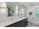 Stylish bathroom featuring double sinks, quartz countertop, modern fixtures, and wallpaper at 1377 Oak Grove Dr, Decatur, GA 30033