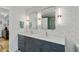 Stylish bathroom featuring double sinks, quartz countertop, modern fixtures, and wallpaper at 1377 Oak Grove Dr, Decatur, GA 30033