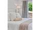 Bedroom featuring plush pillows and blankets on a bed with a view of the outside at 1377 Oak Grove Dr, Decatur, GA 30033