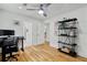 A bedroom with hardwood floors with space for a work area plus black storage shelves at 1377 Oak Grove Dr, Decatur, GA 30033