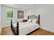 Cozy bedroom featuring a decorative wrought iron bed frame and natural light from the large window at 1377 Oak Grove Dr, Decatur, GA 30033