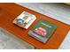 Close-up of a wooden coffee table with books detailing mid-century modern style and Porsche design at 1377 Oak Grove Dr, Decatur, GA 30033