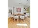 Open concept dining area with hardwood floors, modern lighting, and a stylish serving area at 1377 Oak Grove Dr, Decatur, GA 30033