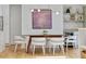 Bright dining area with modern light fixture, seamlessly connecting the kitchen and bar at 1377 Oak Grove Dr, Decatur, GA 30033