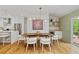 Bright dining area featuring stylish lighting and easy access to the kitchen and outdoor deck at 1377 Oak Grove Dr, Decatur, GA 30033