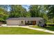 Charming one-story home with a modern exterior, well-maintained lawn, and a spacious driveway at 1377 Oak Grove Dr, Decatur, GA 30033
