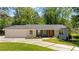 Charming single story home with modern curb appeal, featuring a brick facade and well-manicured lawn at 1377 Oak Grove Dr, Decatur, GA 30033