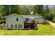 A well-maintained white brick home with a spacious backyard and wooden deck at 1377 Oak Grove Dr, Decatur, GA 30033