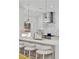 Close up of the modern kitchen featuring white cabinets, stainless appliances, and a breakfast bar with seating at 1377 Oak Grove Dr, Decatur, GA 30033