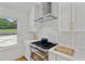 The kitchen has a stainless steel range hood, stainless steel appliances, and gas range cooktop at 1377 Oak Grove Dr, Decatur, GA 30033