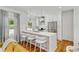 Bright, modern kitchen with white cabinets, stainless steel appliances, and a breakfast bar with seating at 1377 Oak Grove Dr, Decatur, GA 30033