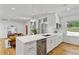 Modern kitchen with stainless steel appliances, quartz countertops, and open layout to the living room at 1377 Oak Grove Dr, Decatur, GA 30033