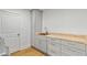 Functional laundry room featuring modern cabinets, a countertop, sink and wooden floors at 1377 Oak Grove Dr, Decatur, GA 30033