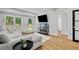 Bright living room featuring a large sectional sofa, modern furniture, and outside access at 1377 Oak Grove Dr, Decatur, GA 30033