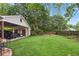 Spacious backyard featuring a fire pit, green lawn, and a detached garage with covered parking at 194 Locust Nw St, Marietta, GA 30064