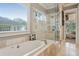 Luxurious bathroom with a soaking tub, a glass shower, and tile flooring at 194 Locust Nw St, Marietta, GA 30064